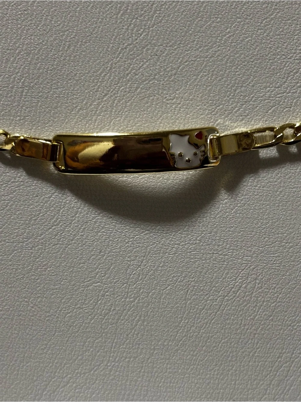 Gold-tone Hello Kitty Accent ID Bracelet. Laminated gold. Everyday use.